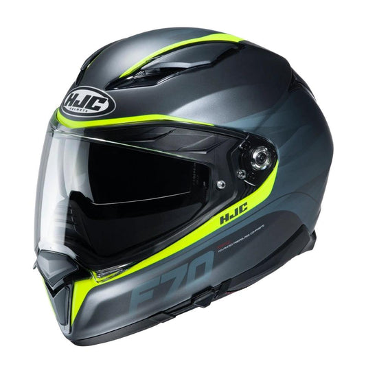 HJC F70 Feron full-face motorcycle helmet in metallic gray with neon-yellow accents and clear face shield.